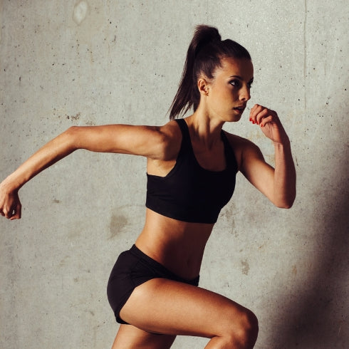 Young female sprinter running